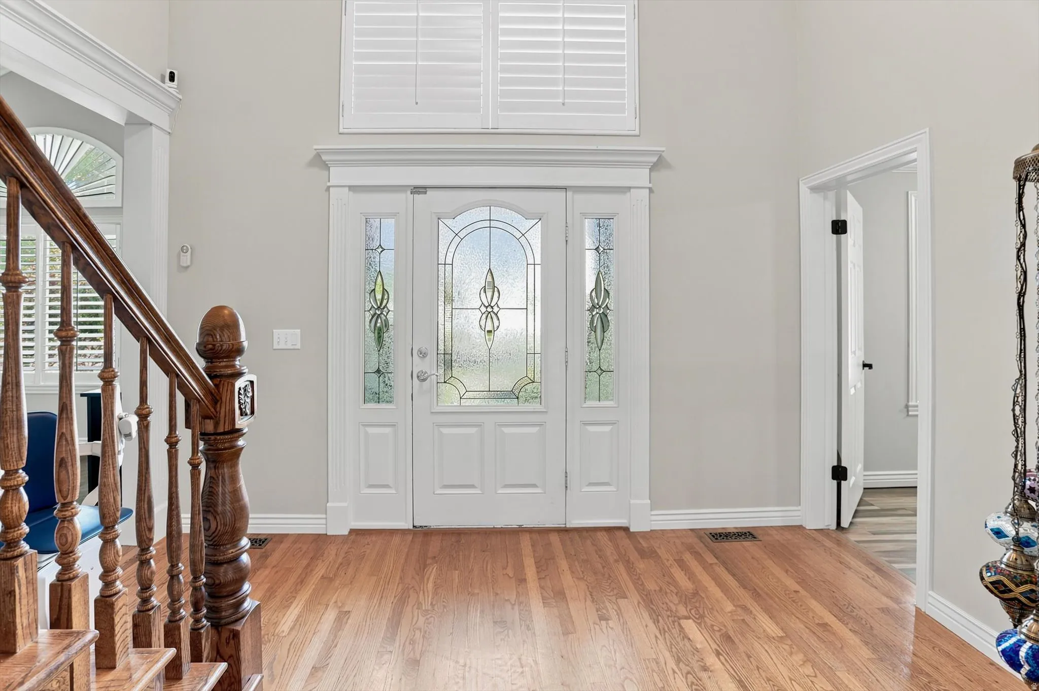 Grand entryway featuring a decorative glass front door, transom window, and sidelights