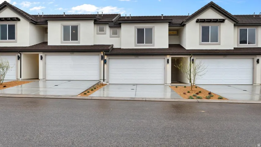 Contemporary townhomes featuring stucco exteriors and dark trim accents
