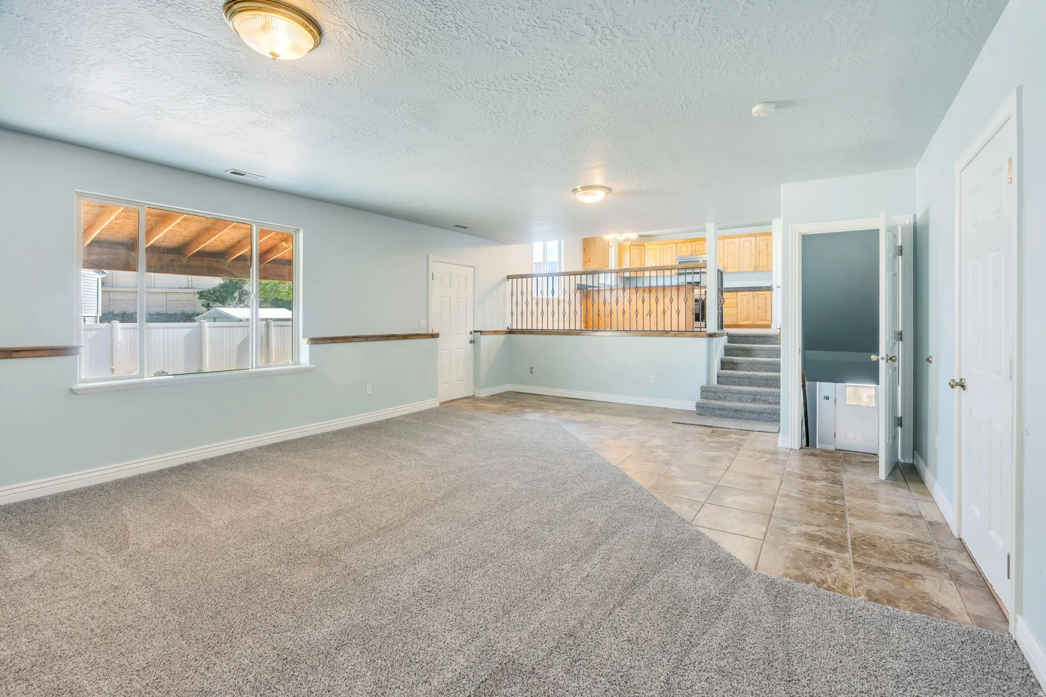 Spacious lower level featuring plush carpeting and tile flooring
