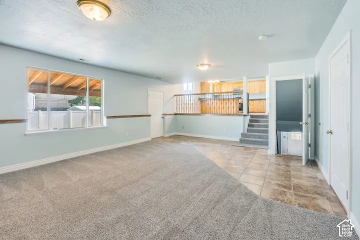 Spacious lower level featuring plush carpeting and tile flooring