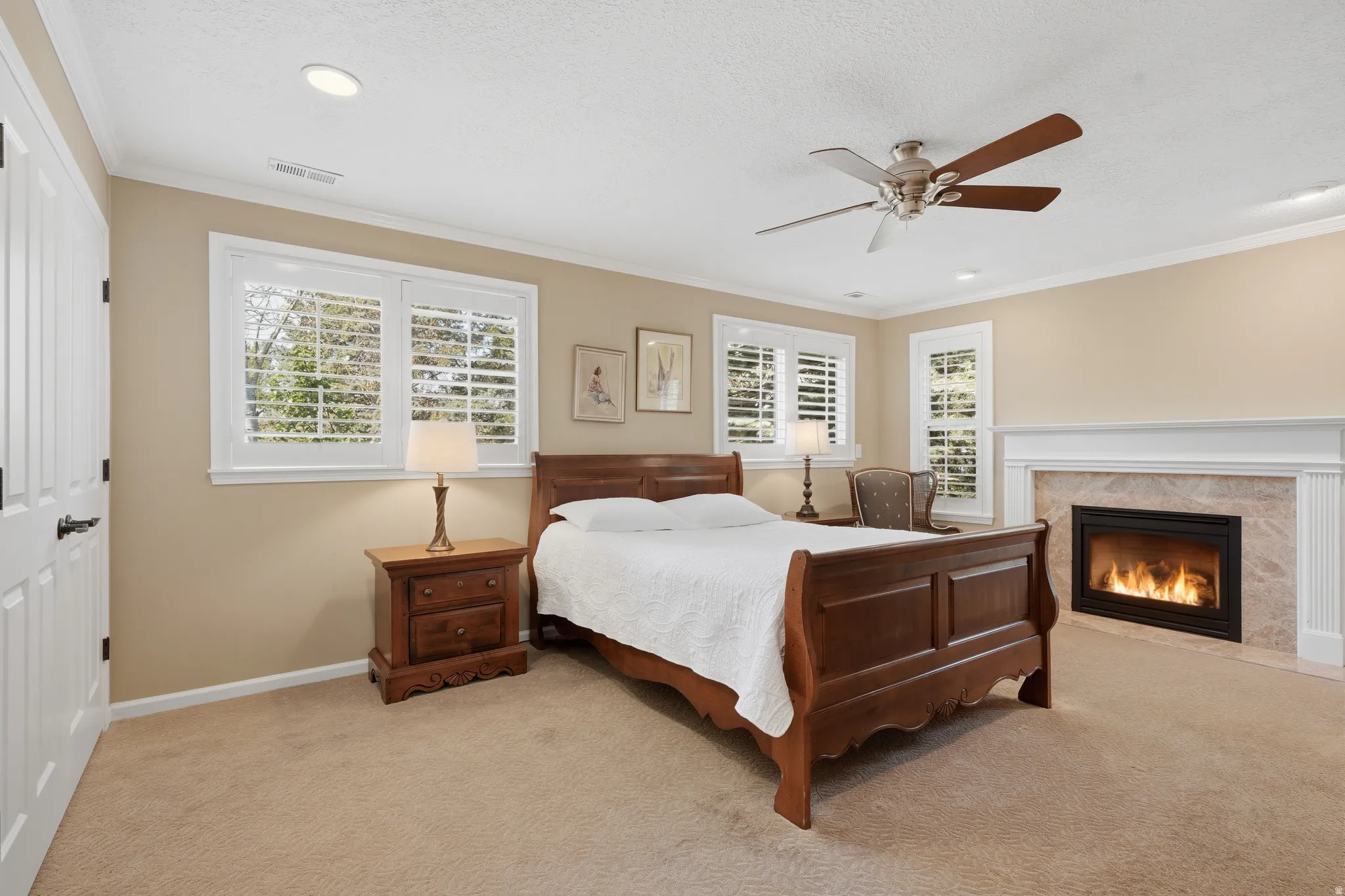Bedroom featuring a built-in fireplace with a stone surround and white mantel