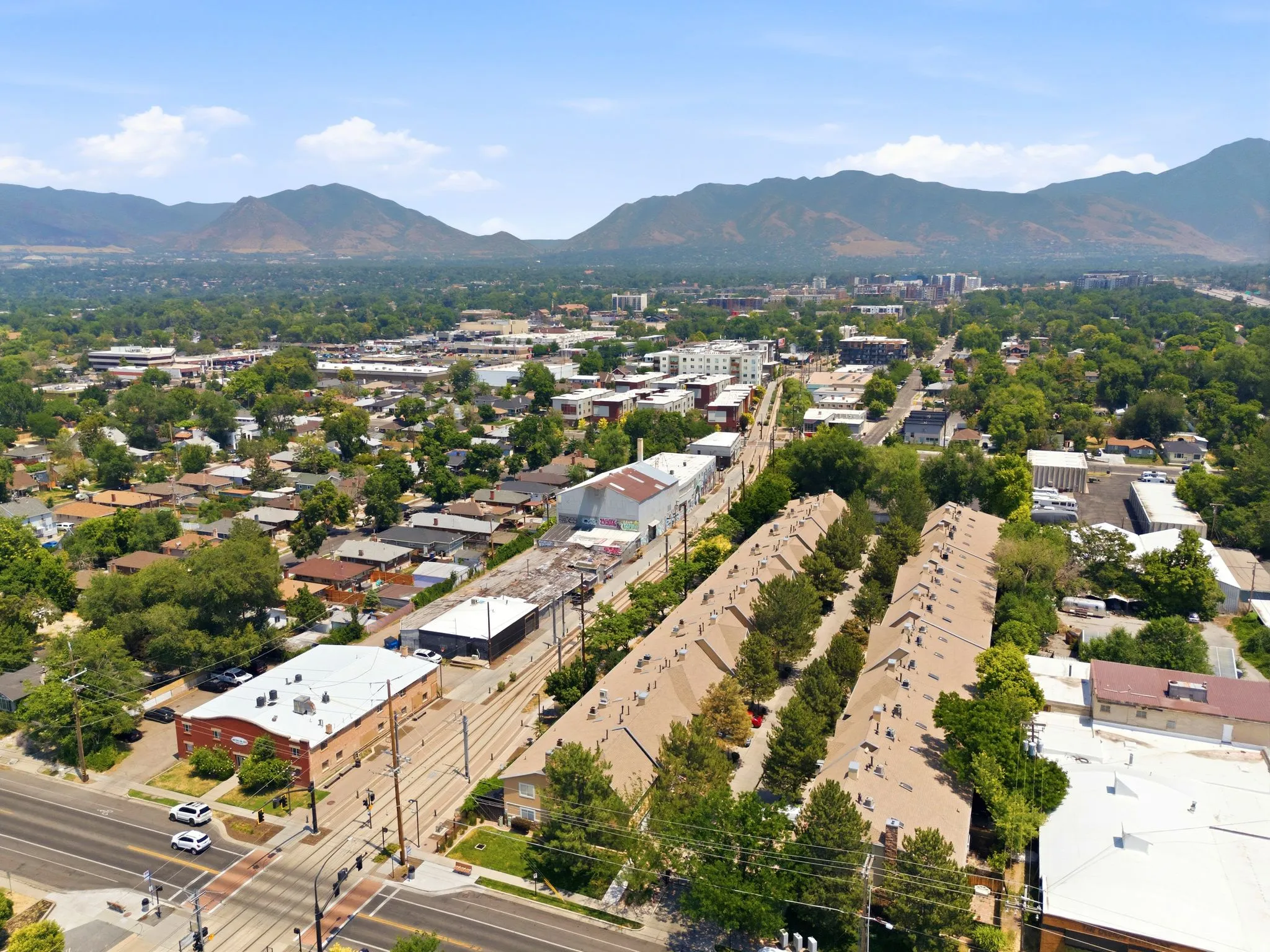 Aerial perspective showcasing a developed urban area with a mountainous backdrop