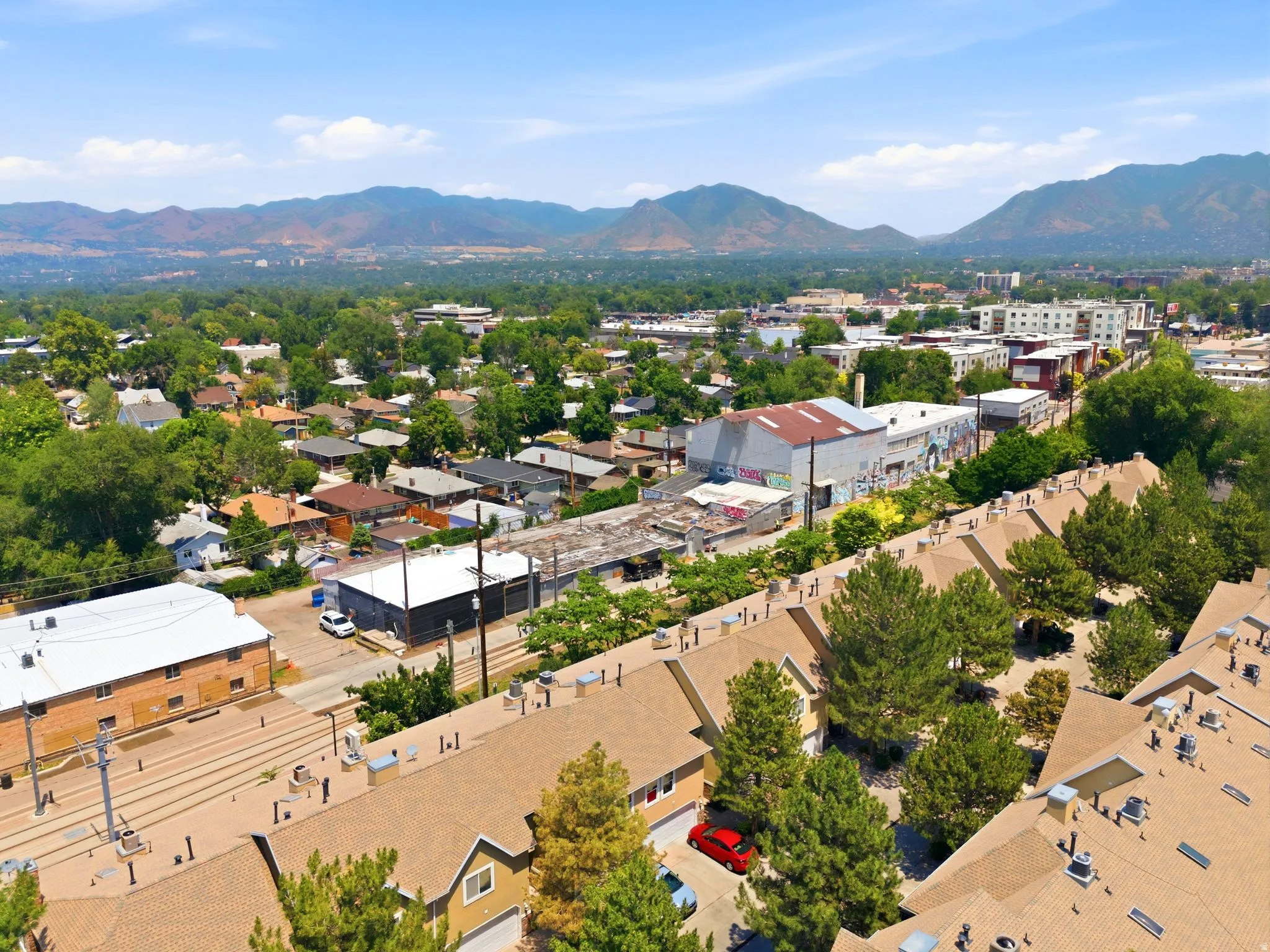 Aerial perspective showcasing residential properties with a mountainous backdrop