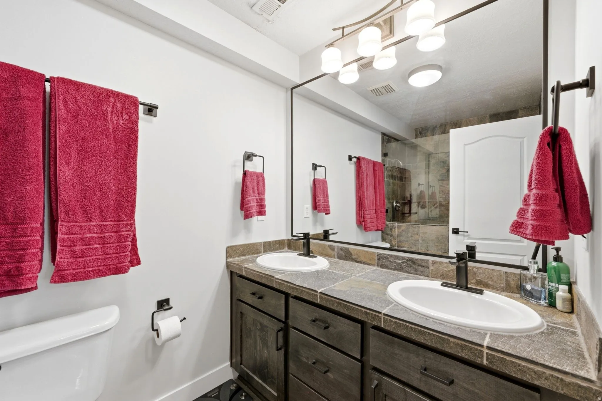 Double vanity with undermount sinks and dark bronze fixtures