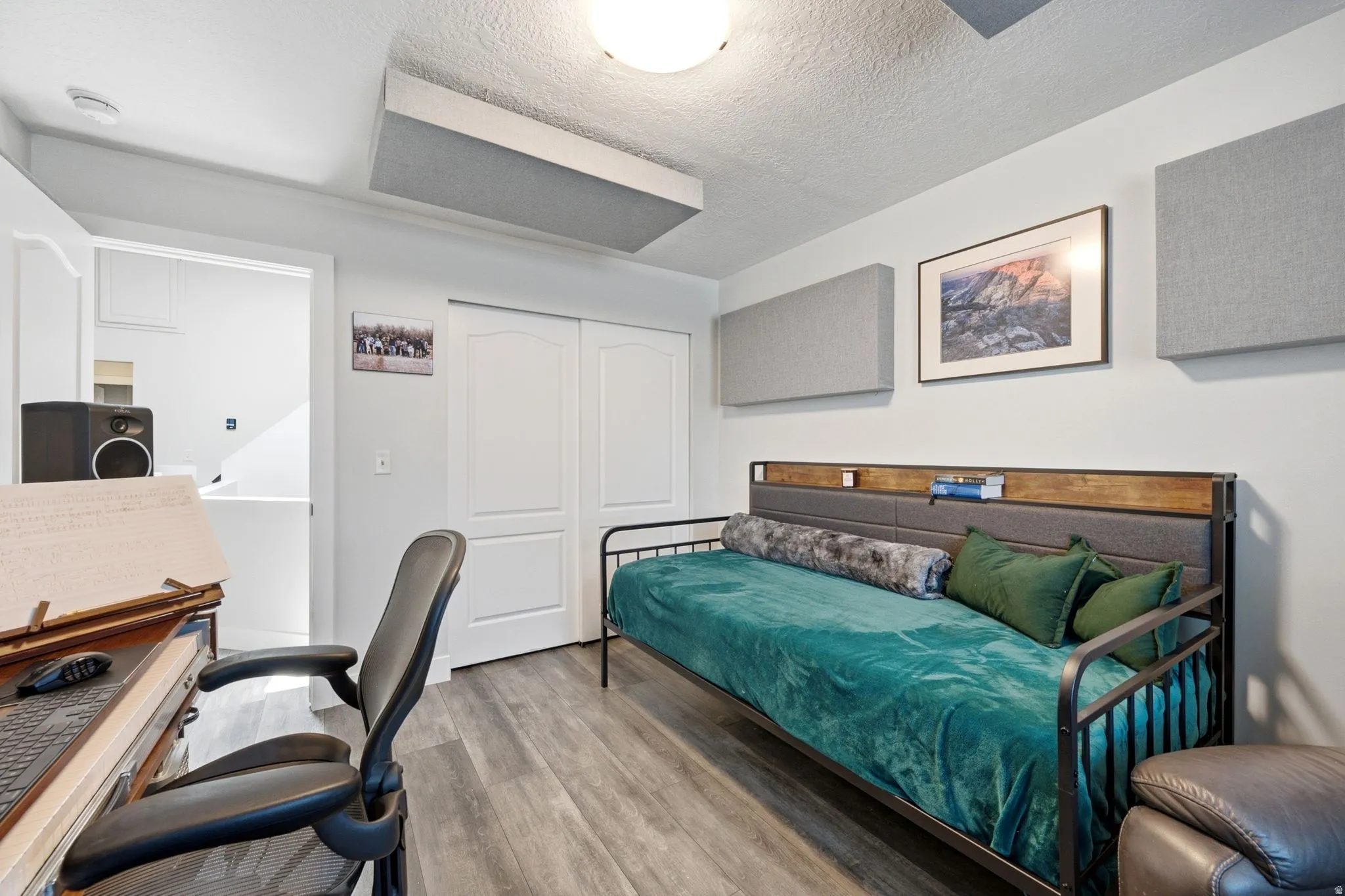 Interior room featuring wood-finish flooring, white walls, and a ceiling-mounted light fixture