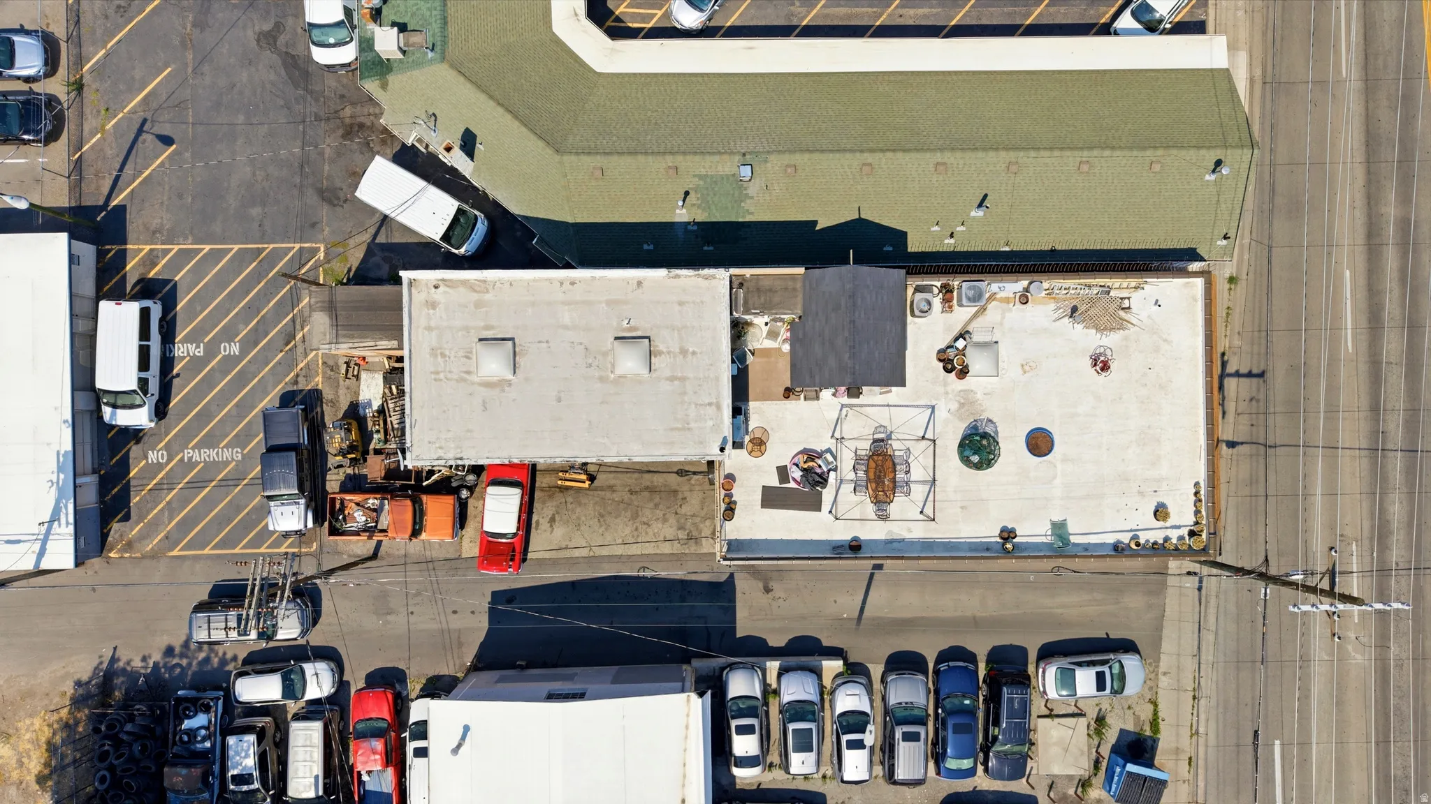 Expansive rooftop space featuring various configurations, including an open-air frame structure and multiple circular design elements