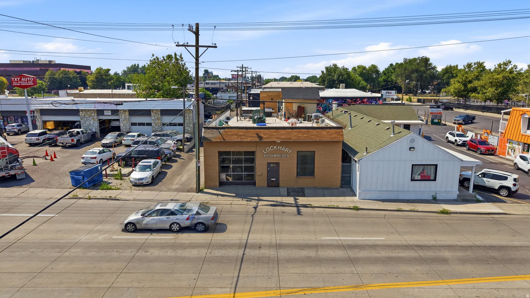 Commercial building featuring an exposed brick facade, a prominent street-facing storefront window, and a flat roofline
