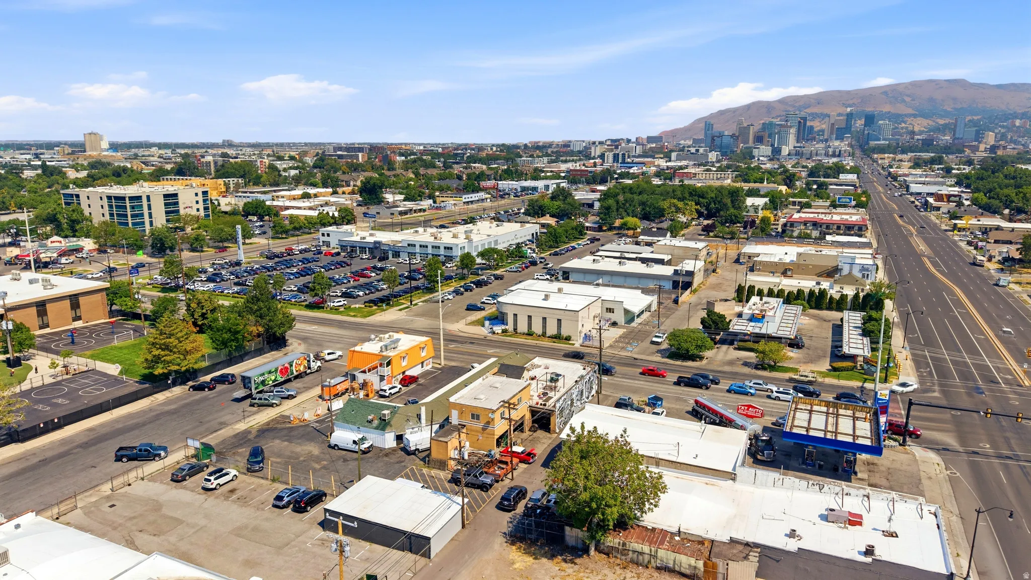 Aerial perspective showcasing an urban environment with commercial buildings and arterial roads