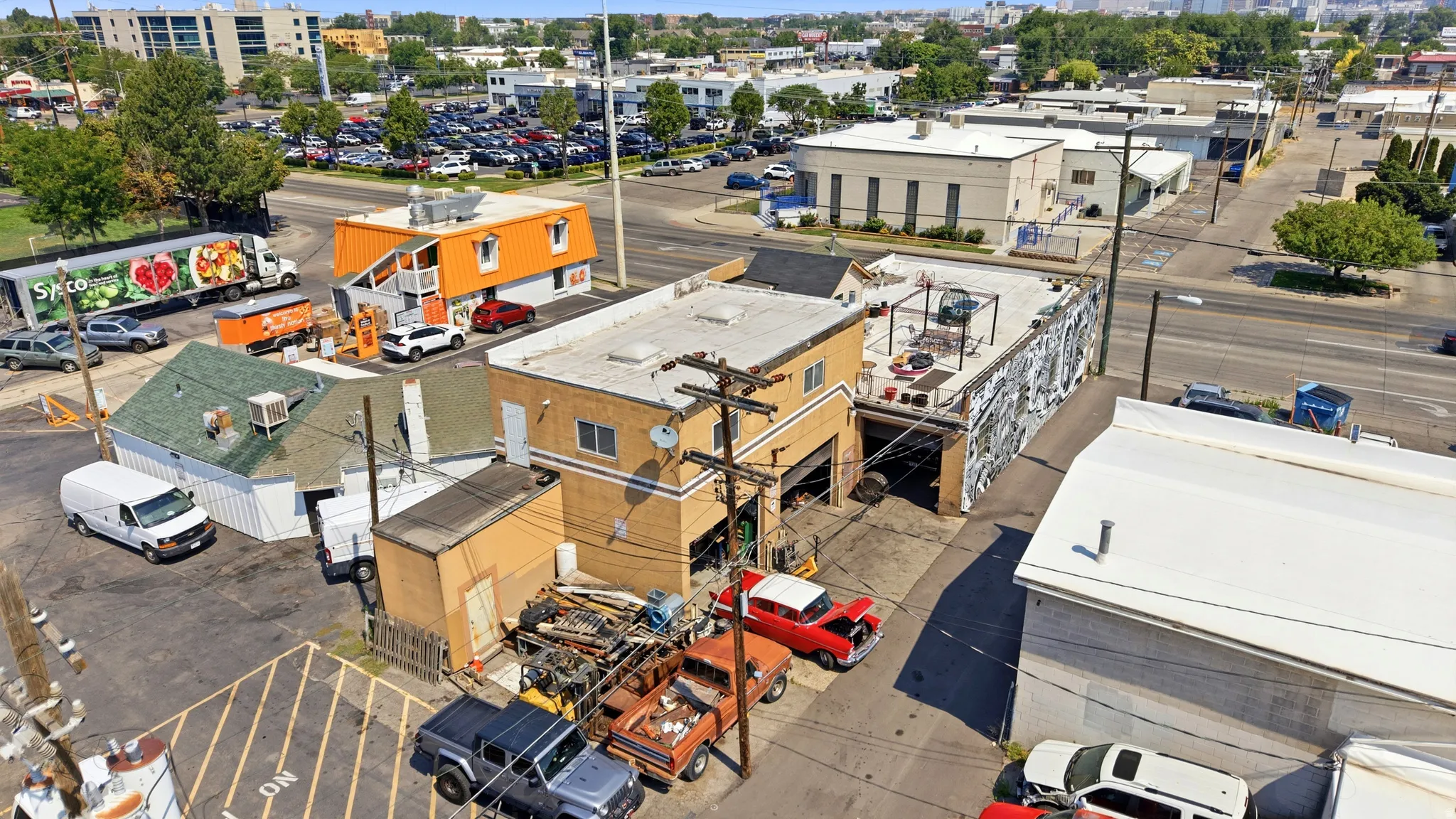 Commercial property featuring multiple single-story buildings and a two-story structure with a flat roof