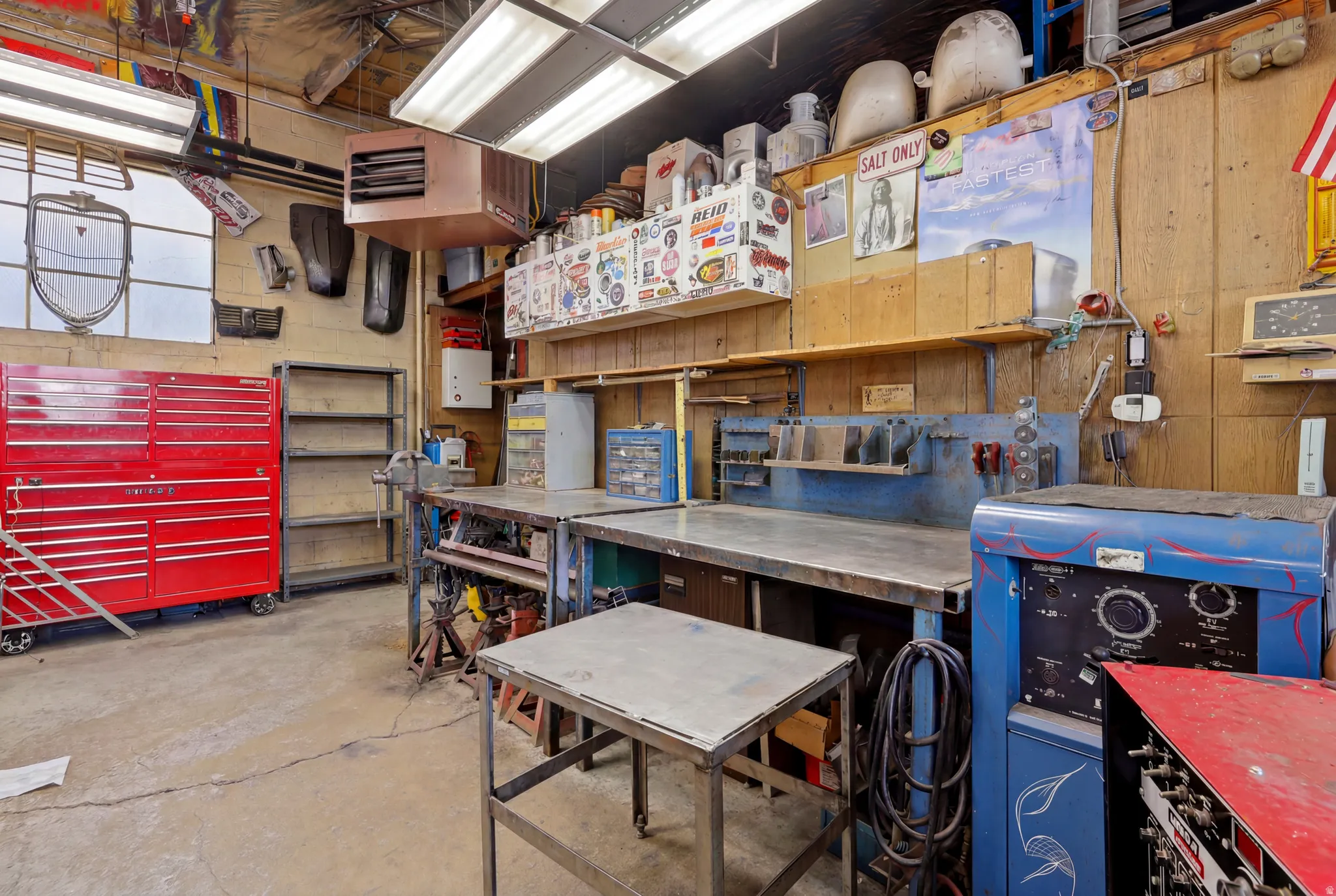 Concrete flooring with ample built-in shelving, workbenches, and storage solutions