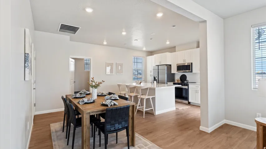 Open-concept living space with wood-finish flooring