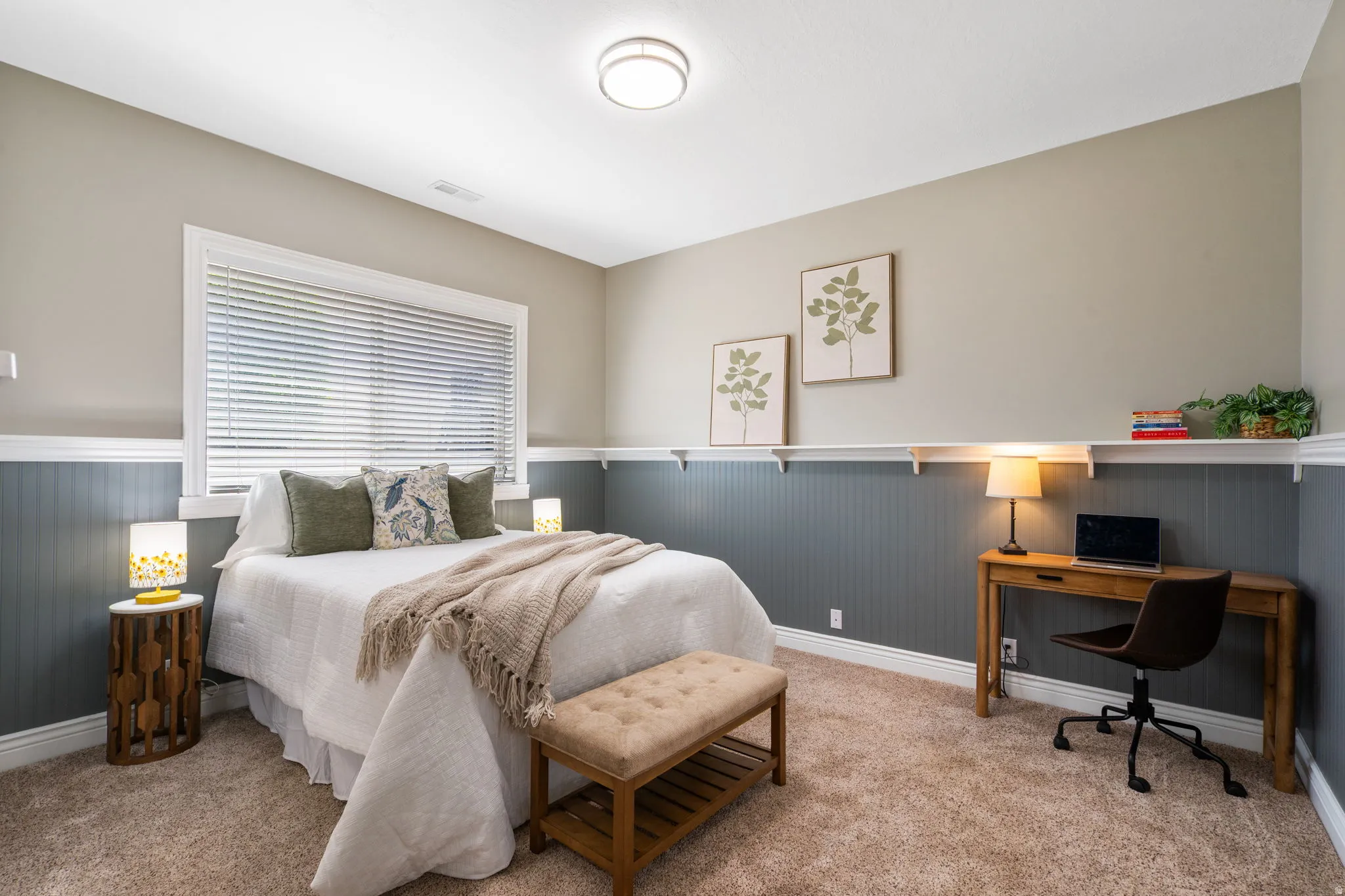 Bedroom 4 is on lower level has custom wainscoting with a ledge, grade level window provides natural light.