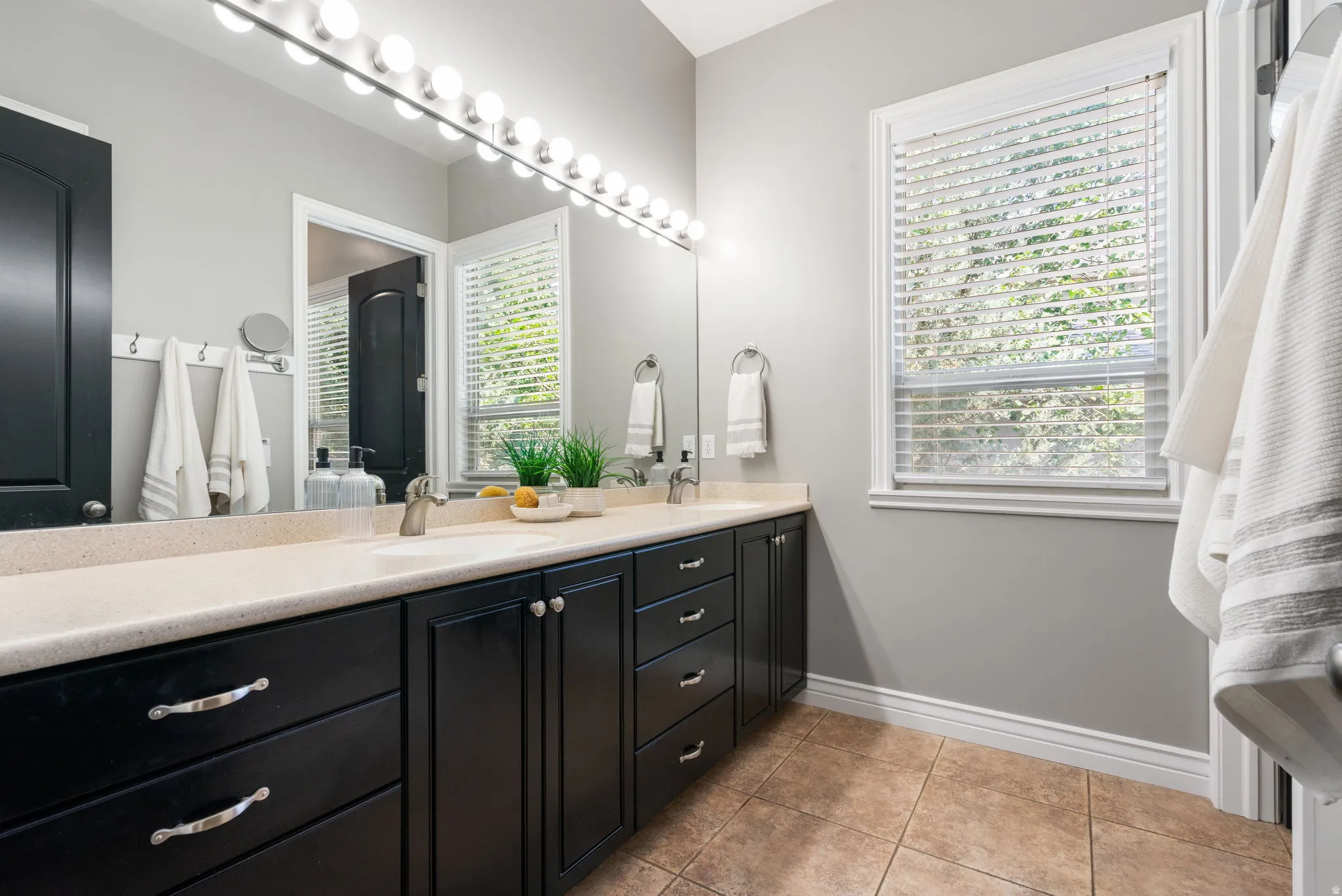 Ensuite primary bath has dual vanity, lots of storage in cabinets and a closet.