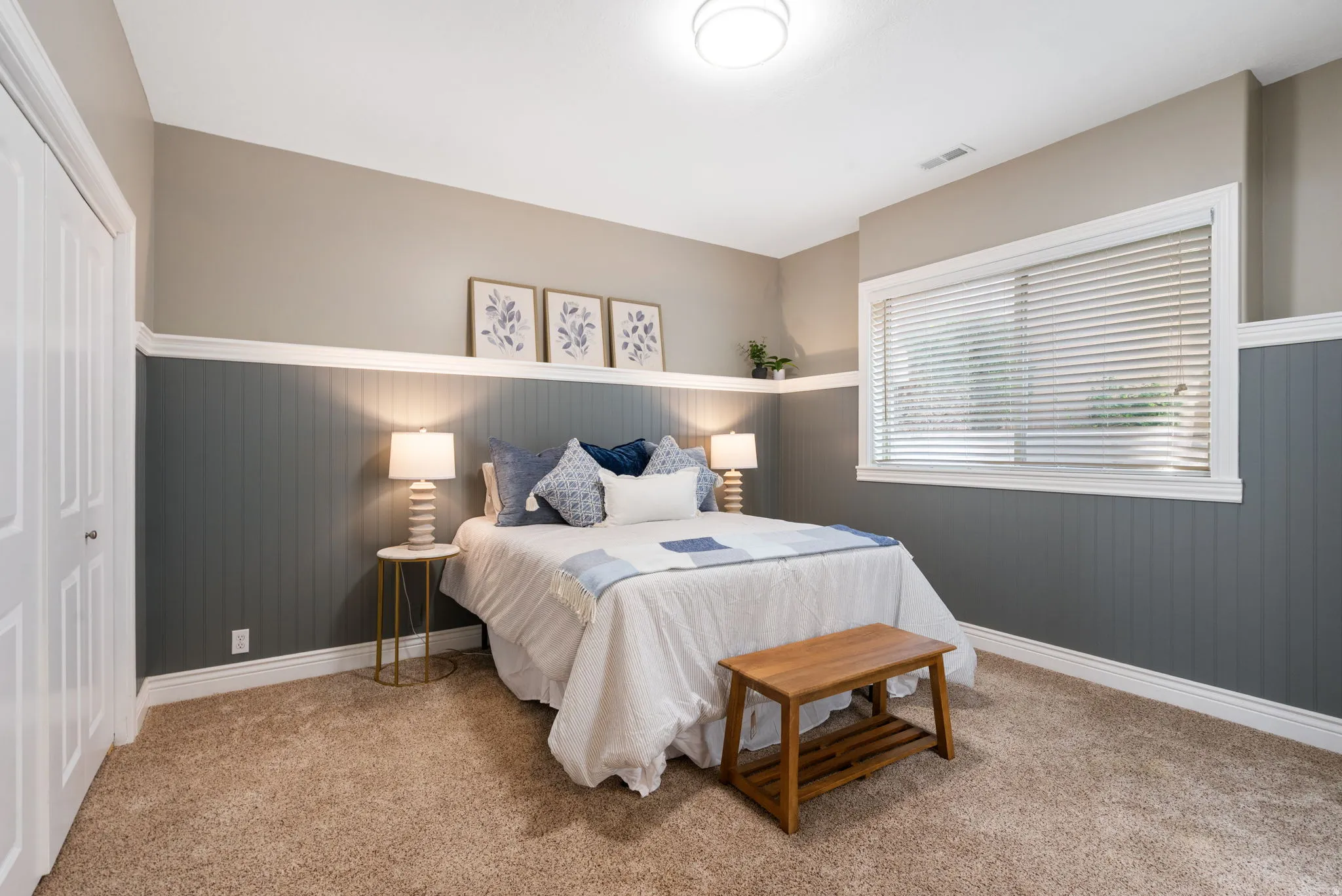 Bedroom 3 is on lower level has custom wainscoting with a ledge, grade level window provides natural light.