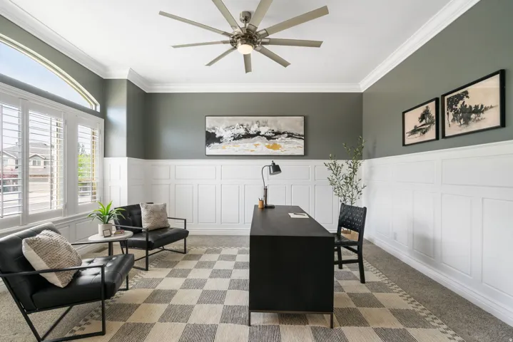 Executive office is elevated by custom millwork, crown molding and beautiful mountain views.