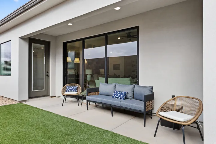 Covered patio featuring a concrete slab and artificial turf