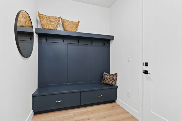Built-in mudroom bench with two storage drawers and three coat hooks