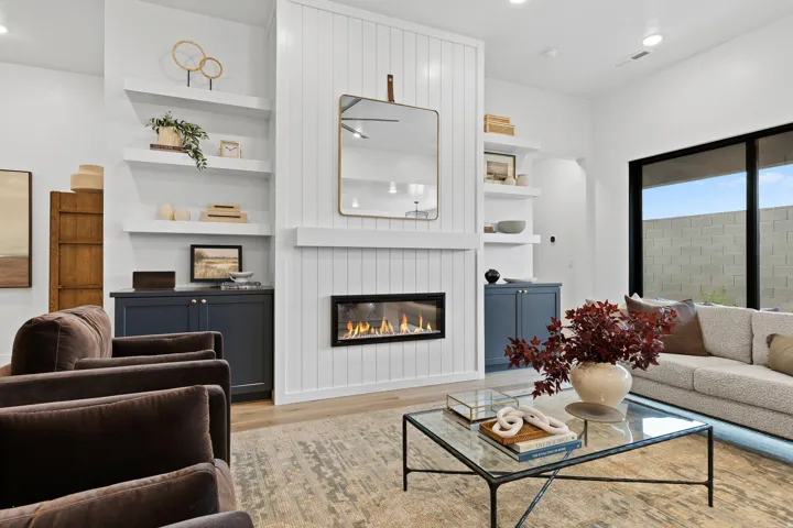 Living area featuring a floor-to-ceiling shiplap fireplace surround with a linear gas fireplace