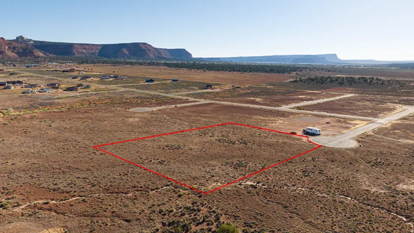 Expansive desert lot featuring natural vegetation and a clear, level building area