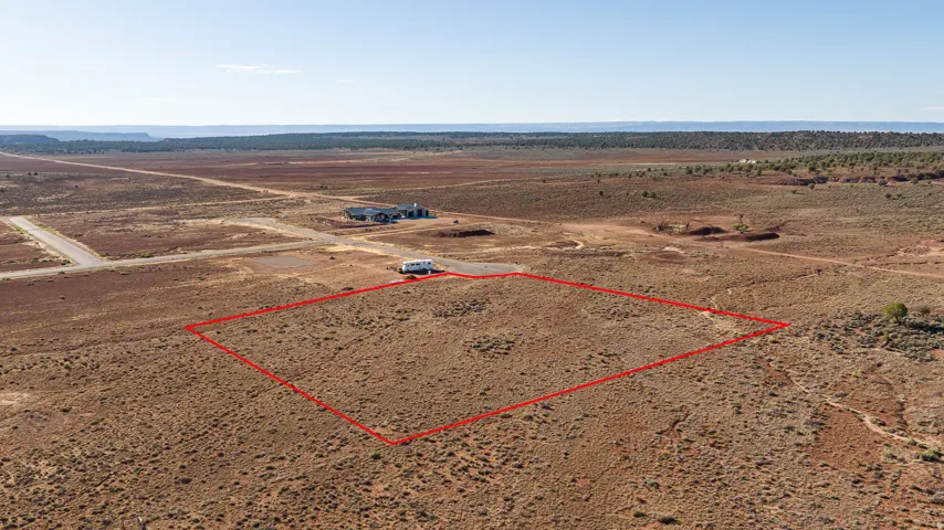 Expansive desert lot featuring a defined perimeter, natural scrub vegetation, and a flat topography