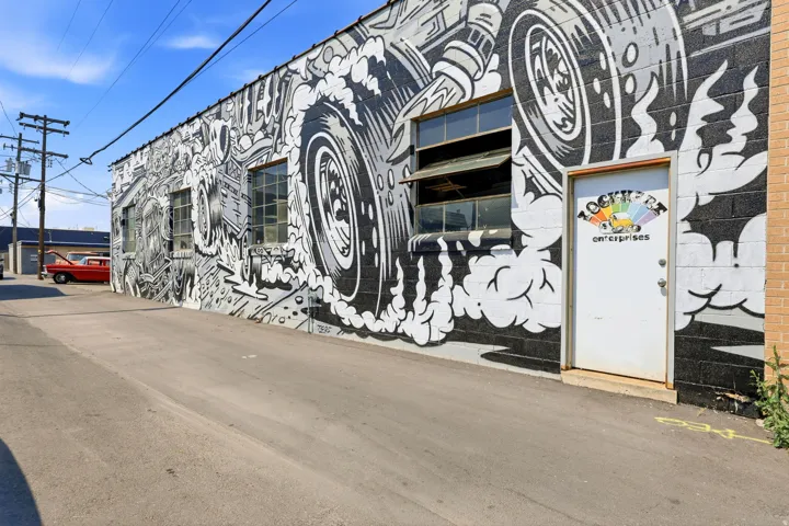 Industrial building exterior featuring a black and white mural