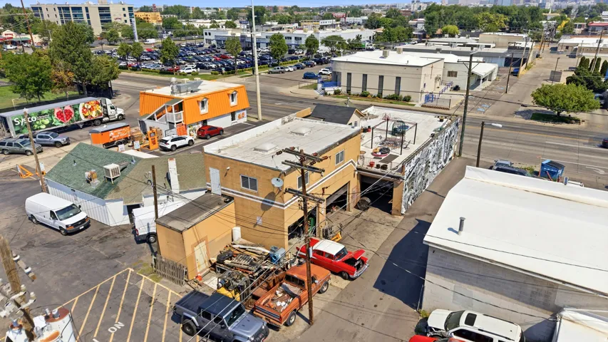 Commercial property featuring multiple single-story buildings and a two-story structure with a flat roof