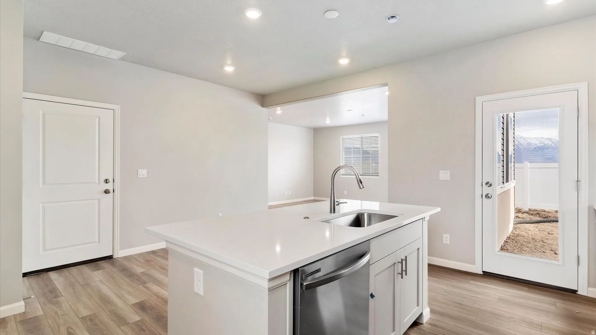 Kitchen island with an undermount sink and stainless steel dishwasher