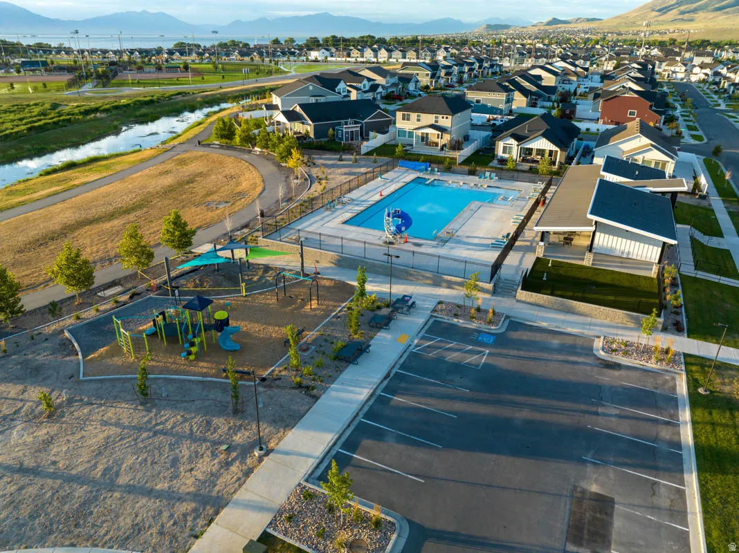 Community amenities featuring a swimming pool, playground, and paved walking paths