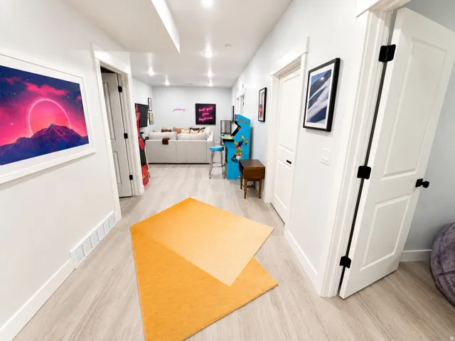 Hallway with light wood-finish flooring, recessed lighting, and white baseboards