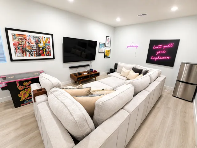 Spacious room featuring light wood-finish flooring and recessed ceiling lighting