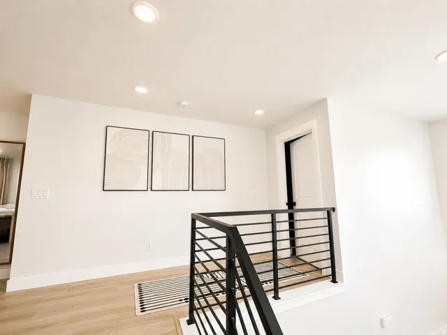Upper-level hallway with contemporary horizontal metal railings