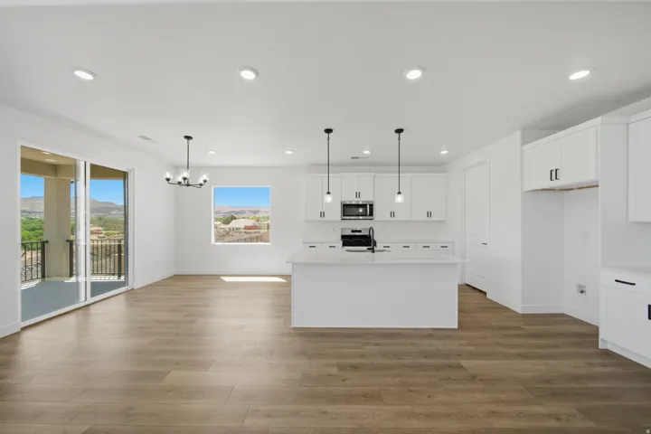 Open-concept living area featuring wood-finish flooring and recessed lighting