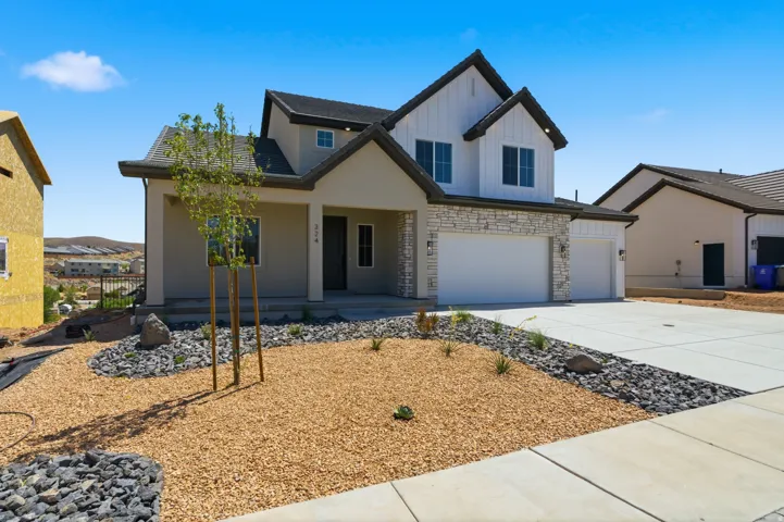 Modern two-story residence featuring a combination of stucco and vertical white siding, stone accents, and a dark shingle roof
