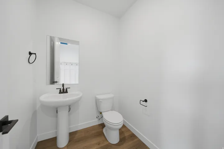 Pedestal sink with matte black faucet and matching towel ring