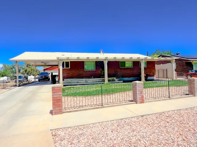 Brick exterior with a covered carport and an additional covered patio area