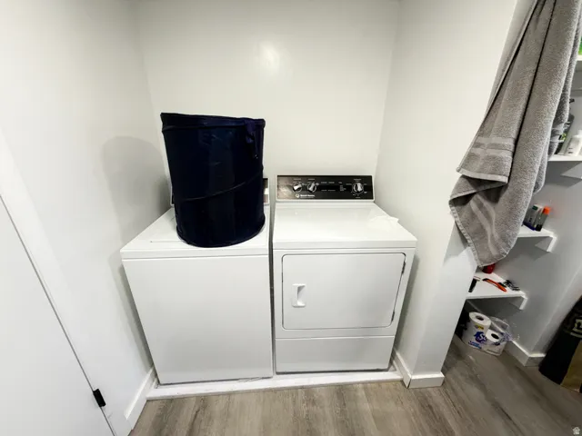 Dedicated laundry area featuring a white top-load washing machine and a white front-load dryer
