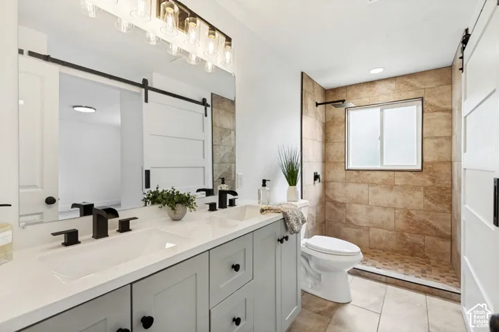 Jack and Jill Bathroom attached to the primary bedroom. Dual vanity with undermount sinks, quartz countertop, and matte black fixtures