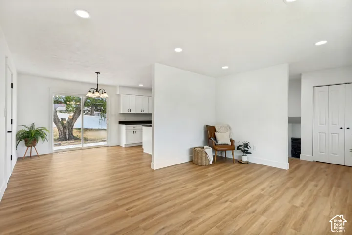 Spacious interior featuring LVP flooring, recessed lighting, and white walls