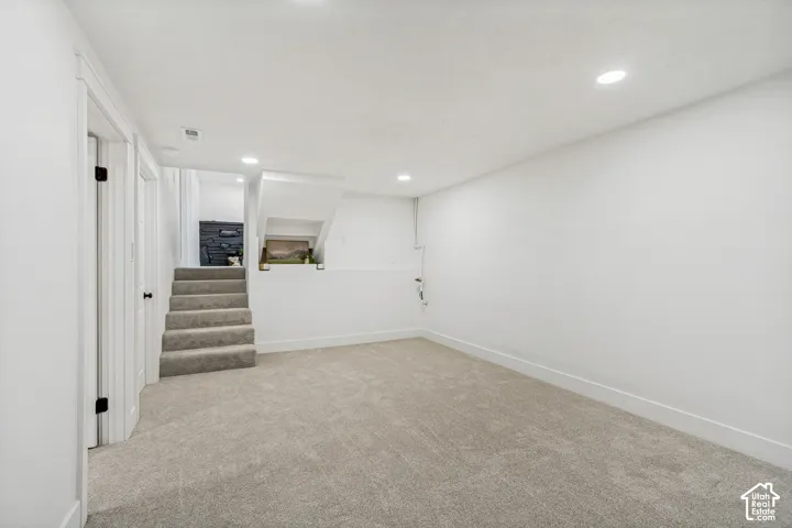 Spacious family/flex room #2 featuring neutral carpet flooring, recessed lighting, and crisp white walls