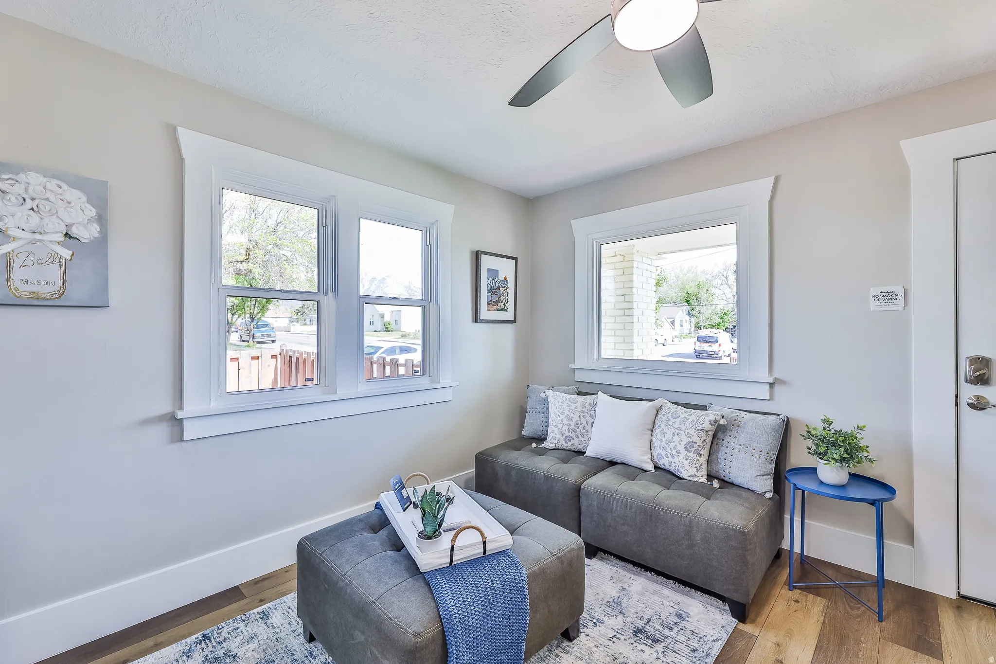 Bright room featuring light-toned walls, wood-finish flooring, and white trim