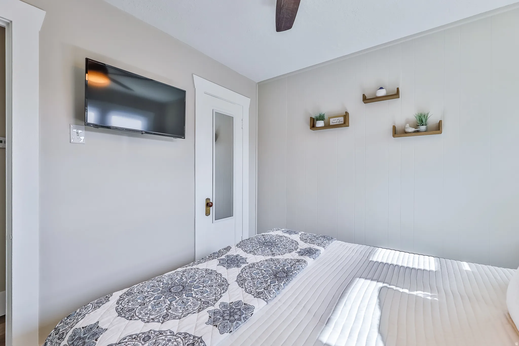 Interior space featuring light gray walls and a ceiling fan