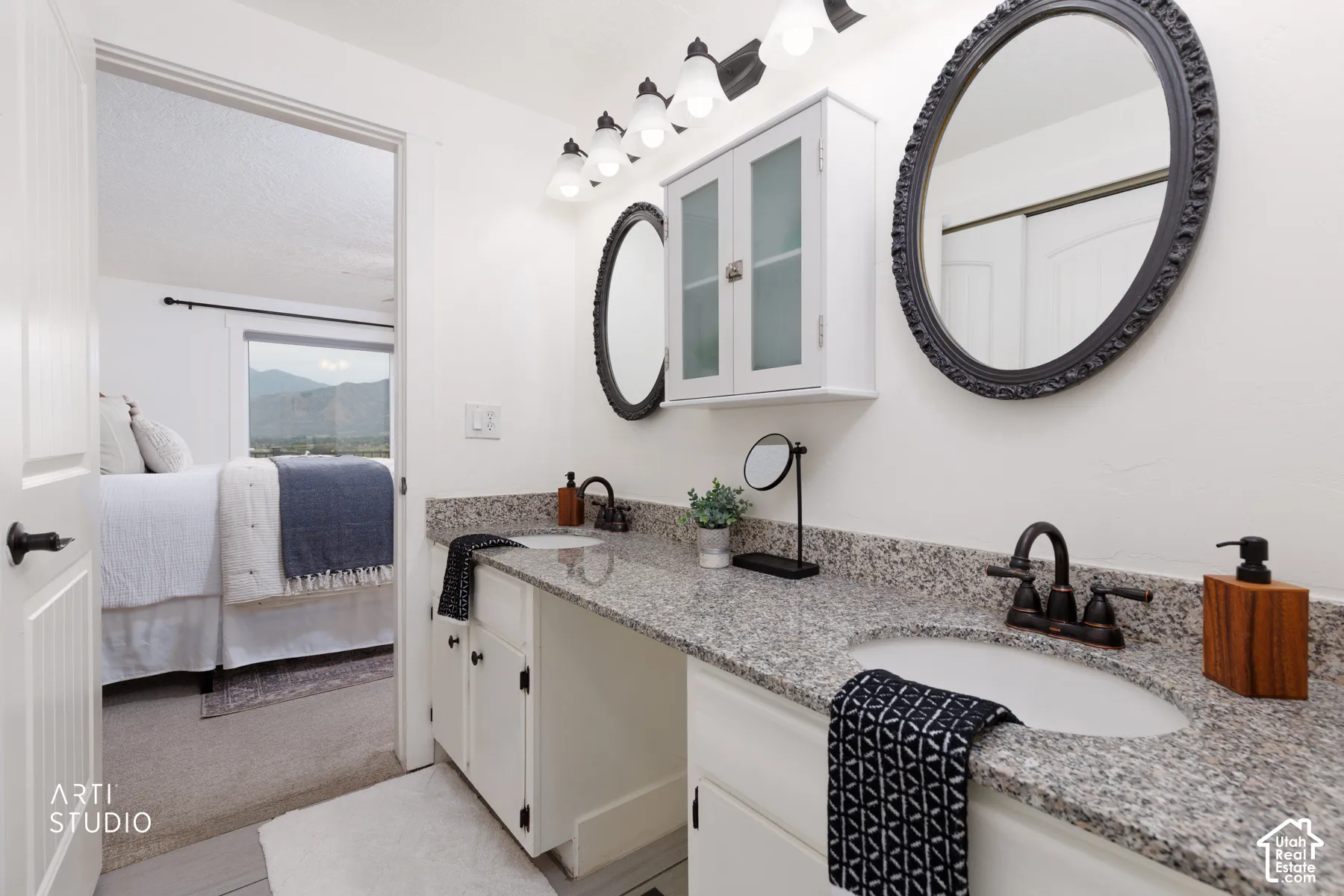 Double vanity featuring quartz-finish countertops, undermount sinks, and oil-rubbed bronze fixtures