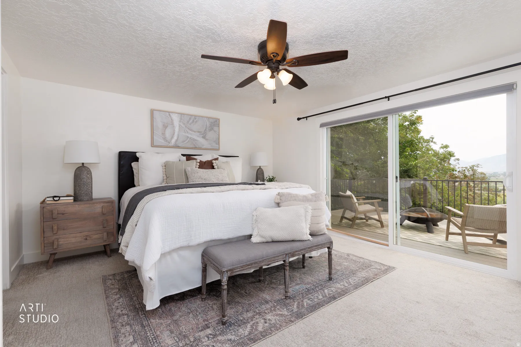 Bedroom featuring a ceiling fan with integrated lighting, soft carpeting, and a large sliding glass door opening to an outdoor deck