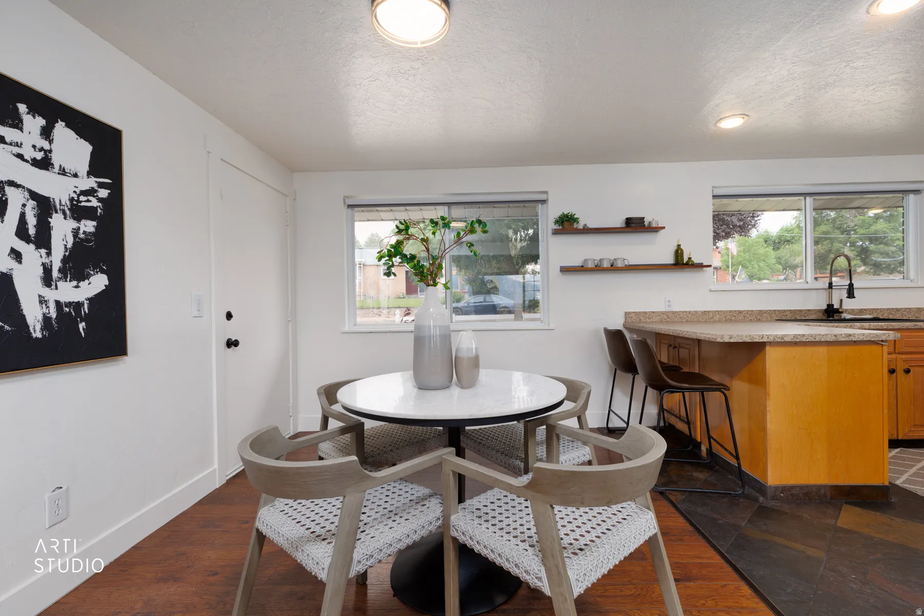 Open-concept dining space with wood-finish flooring