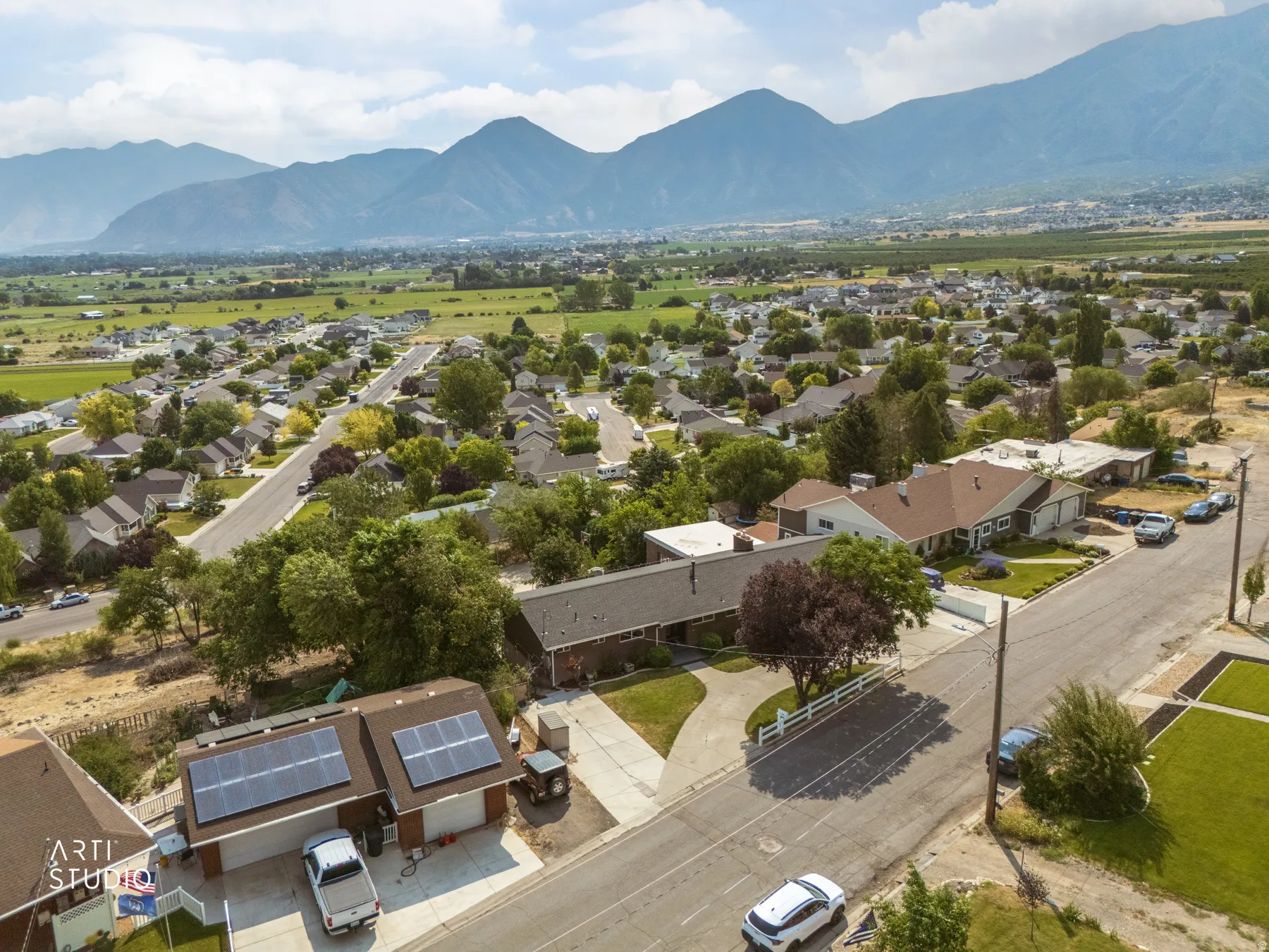 Aerial perspective highlighting a residential neighborhood with mountain backdrop