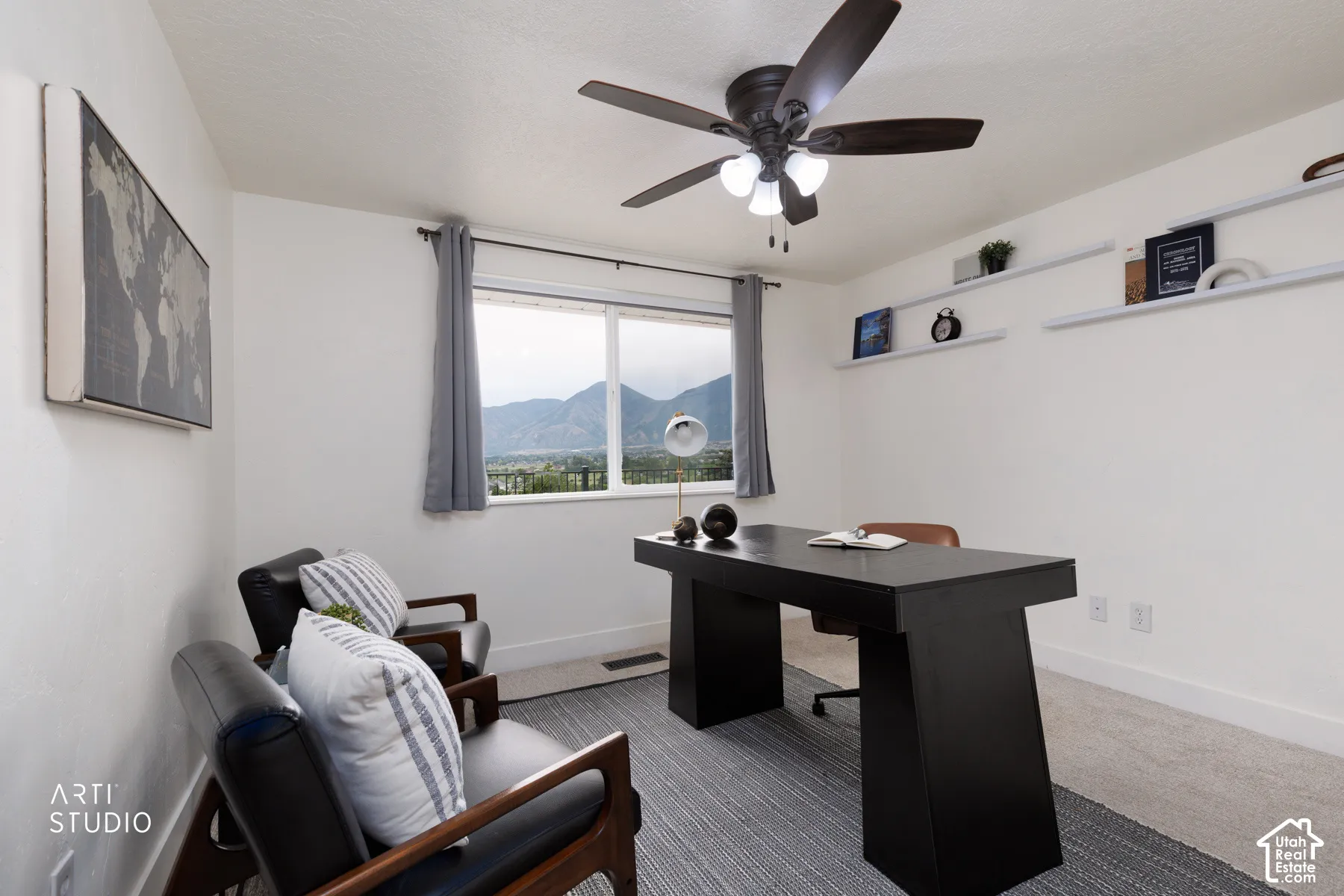Room featuring a window with mountain scenery, a ceiling fan with integrated lighting, and white floating wall shelves
