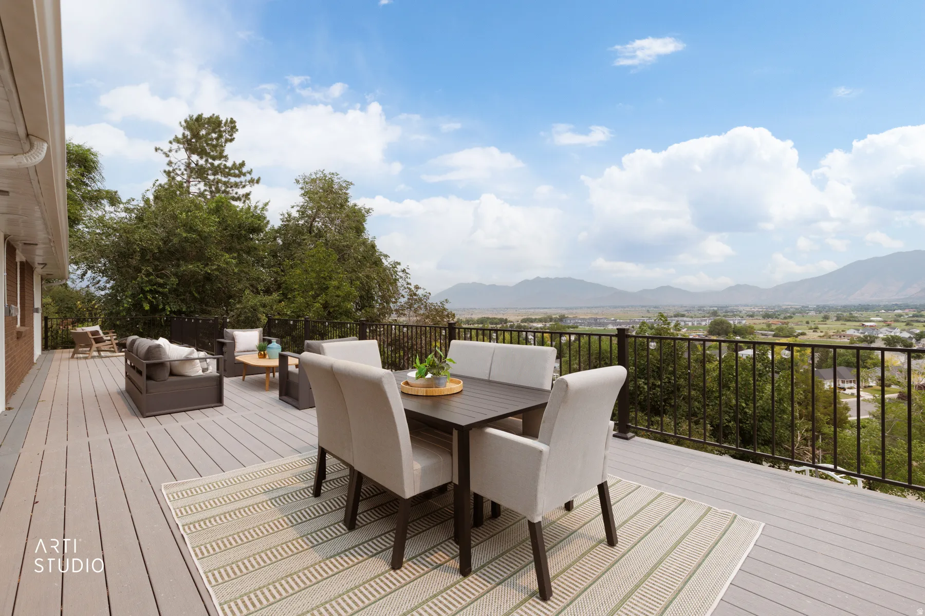 Expansive outdoor deck featuring wood-finish composite decking and black metal railing