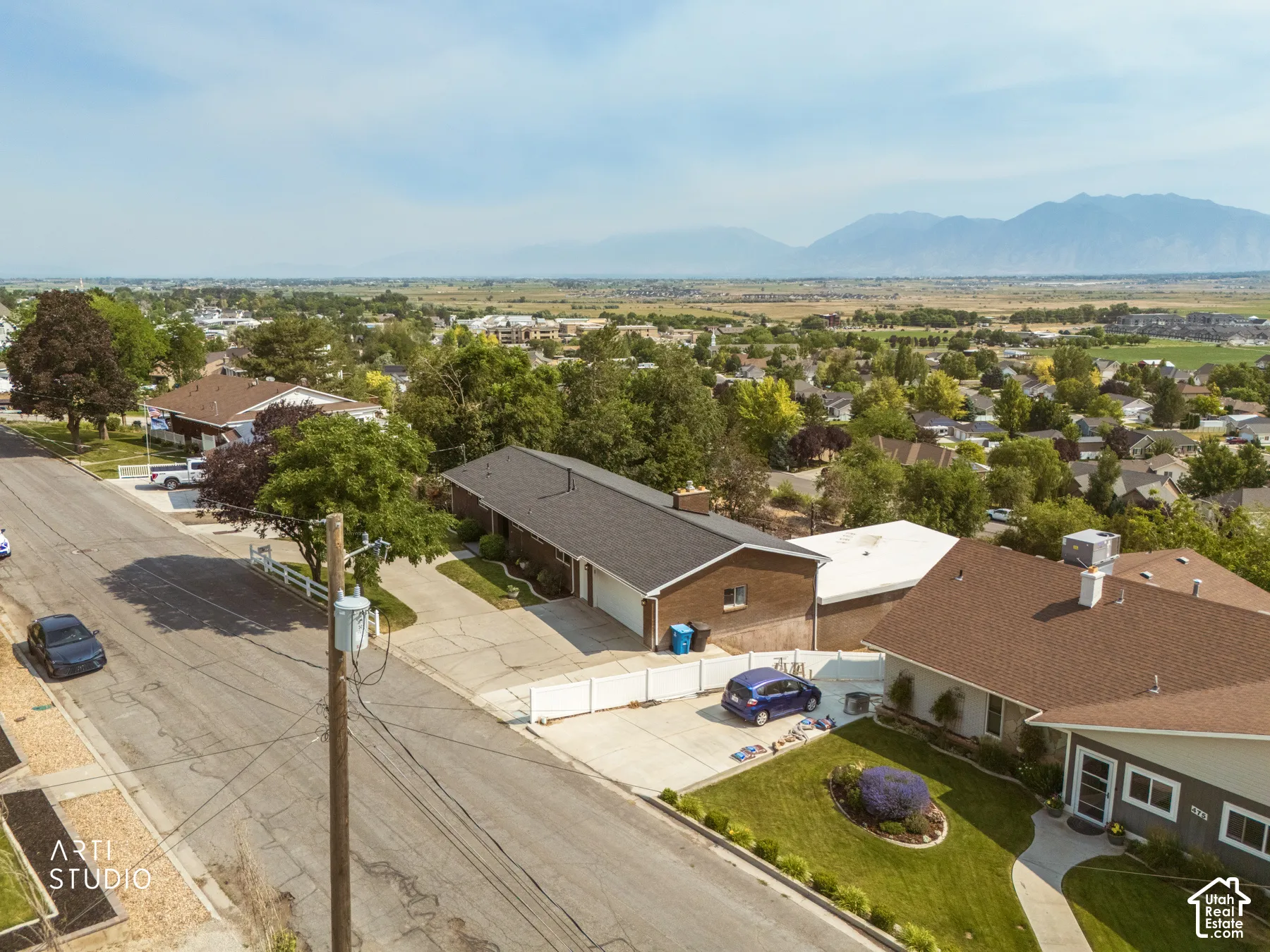 Aerial perspective showcasing a residential street with mountain scenery