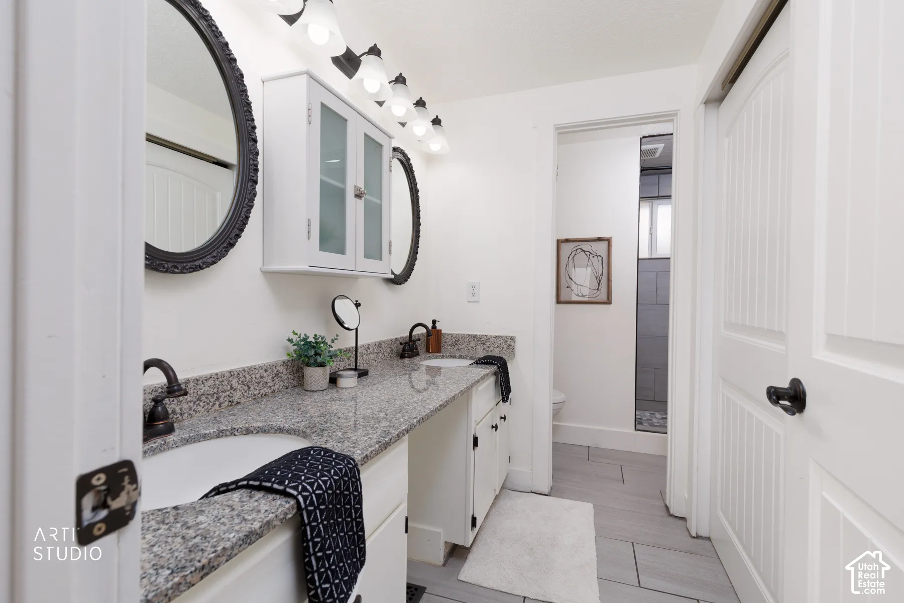 Dual vanity featuring an extended quartz-finish countertop with two undermount sinks