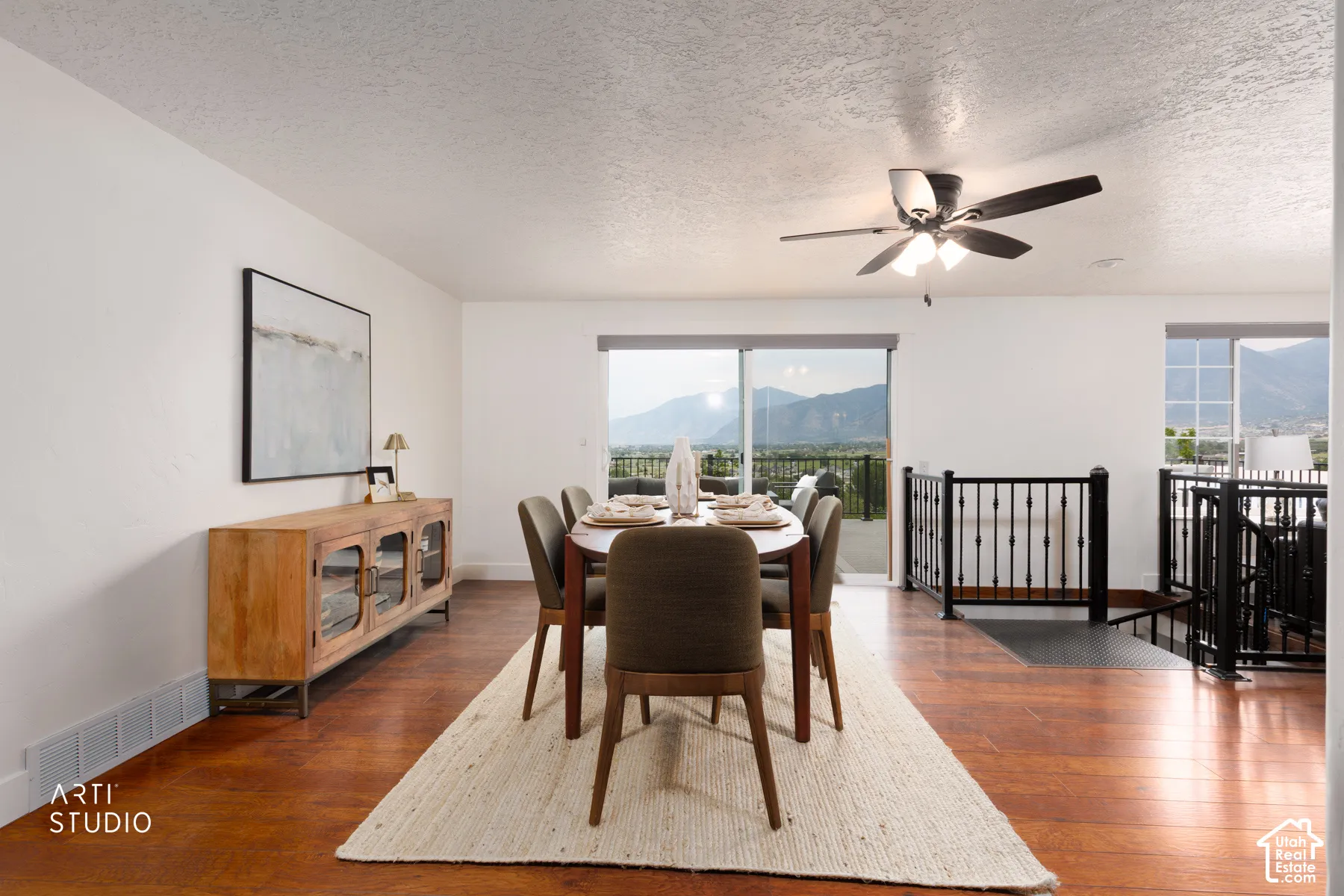 Dining area with wood-finish flooring, a contemporary ceiling fan, and sliding glass doors opening to a balcony